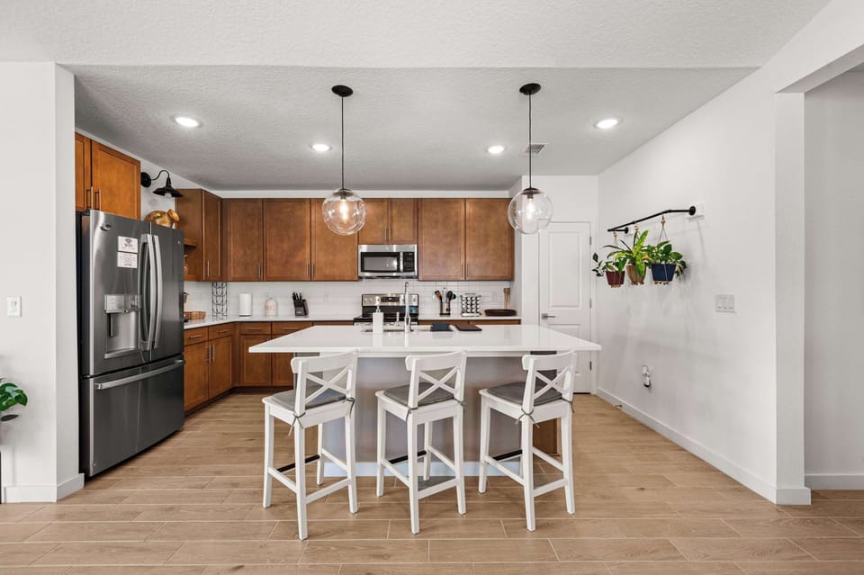 Spacious open kitchen with large island & stylish pendant lights