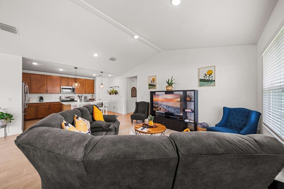 Spacious living room with smart TV, cozy sectional sofa