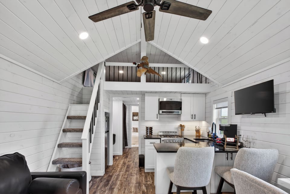 Bright lofted tiny home with vaulted ceilings and a stylish kitchenette