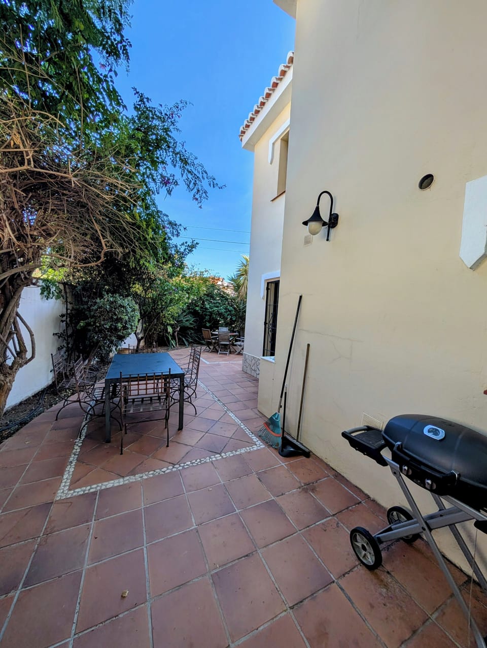 Outdoor dining area with bbq.