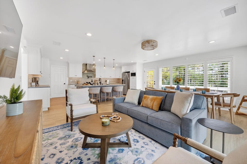 The grand great room provides effortless indoor-outdoor flow, with sliding doors leading straight out to the patio.