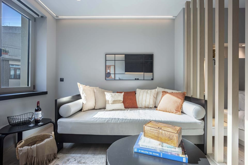 Sunlit sofa nook frames charming city views, offering inviting relaxation with stylish comfort and thoughtful design.
