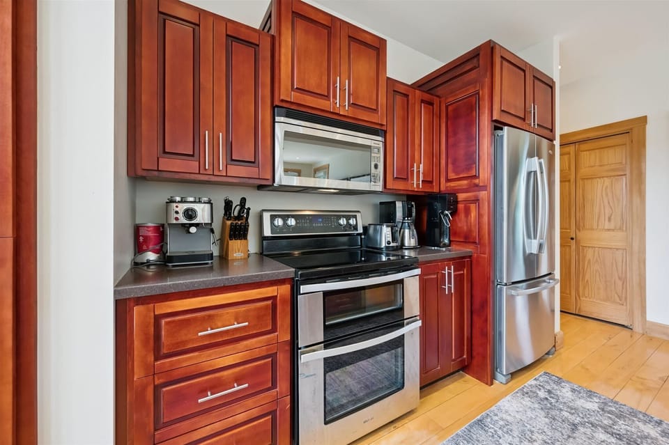 Fully equipped kitchen with modern appliances and ample prep space for group meals.