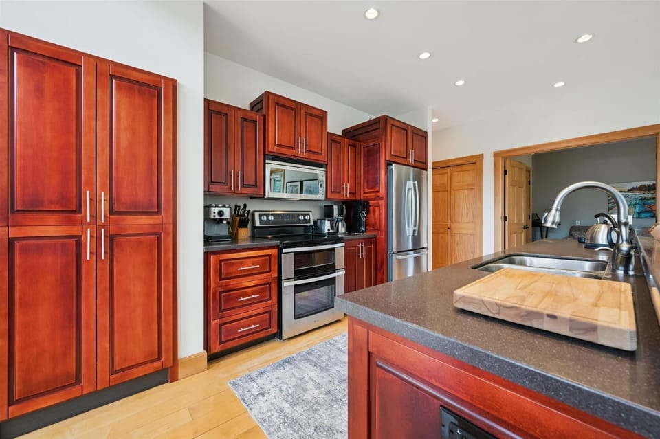 Modern kitchen featuring stainless steel appliances and beautiful wood cabinetry.