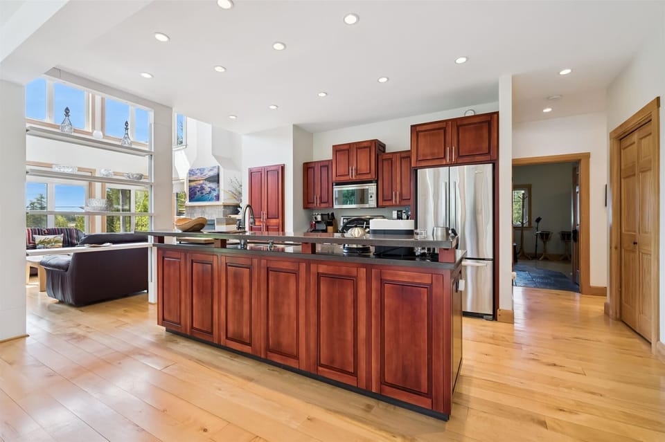 Modern chef’s kitchen with large island seating and open-concept design.