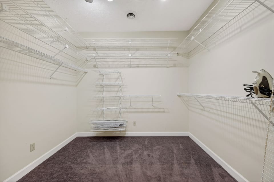 Spacious walk-in closet with ample storage and shelving for longer stays and group travel.
