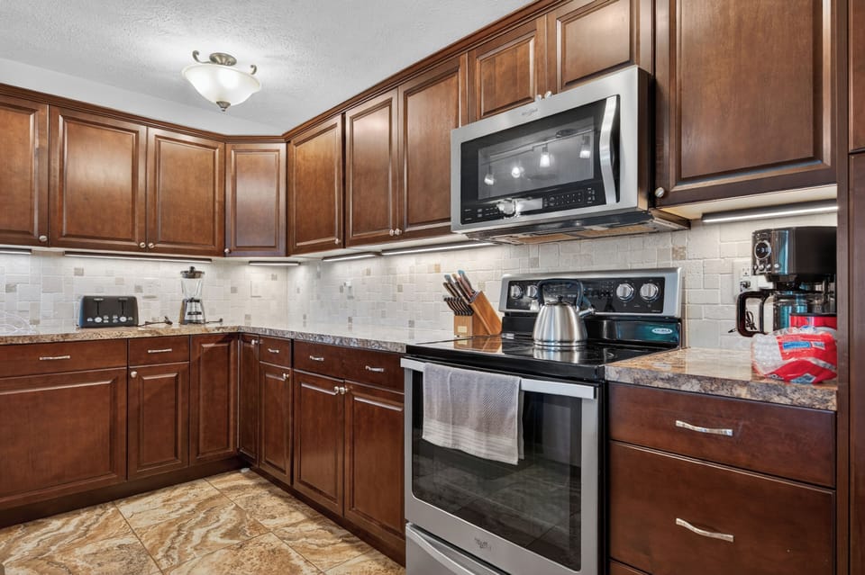 Fully equipped kitchen with spacious countertops and plenty of room for preparing meals during your stay.
