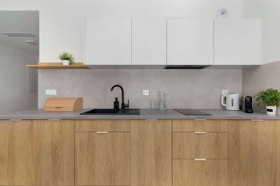 The sleek design of the kitchenette blending seamlessly with the living area.