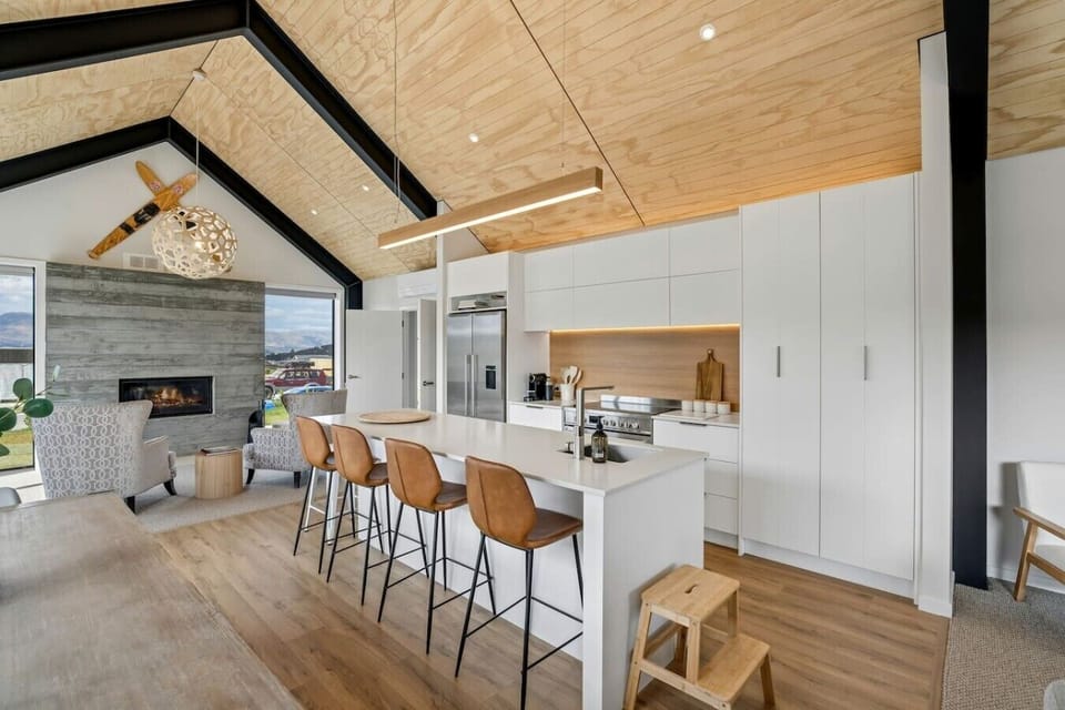 Expansive open-plan kitchen and living area bathed in natural light, with premium finishes throughout