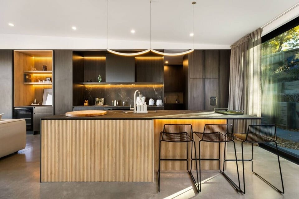 Gather around your sleek kitchen island for morning coffee and evening conversations in this stunning modern space