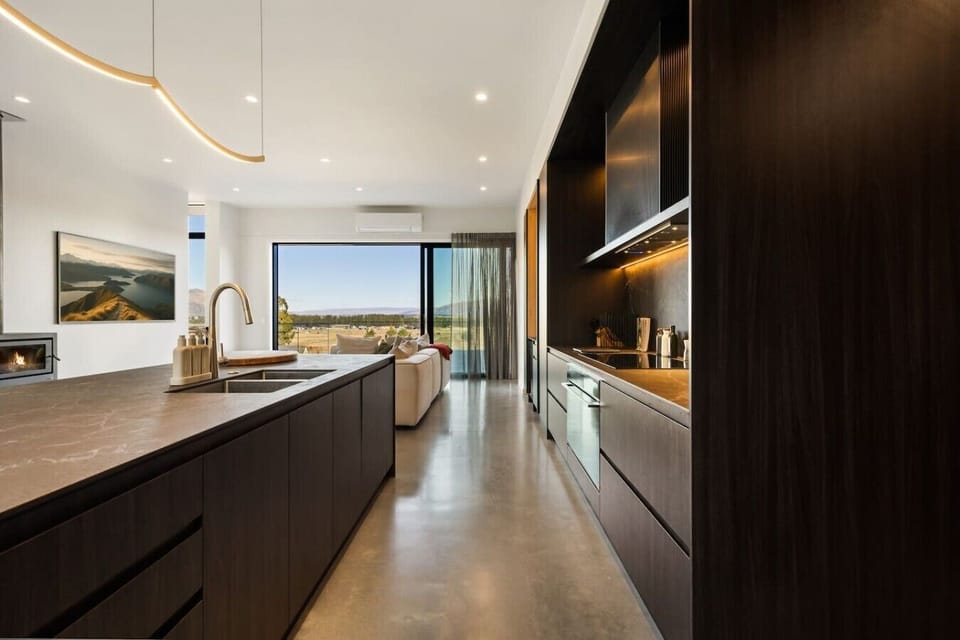 Whip up your feast in this sleek galley kitchen with marble counters and golden hour views stretching to the horizon