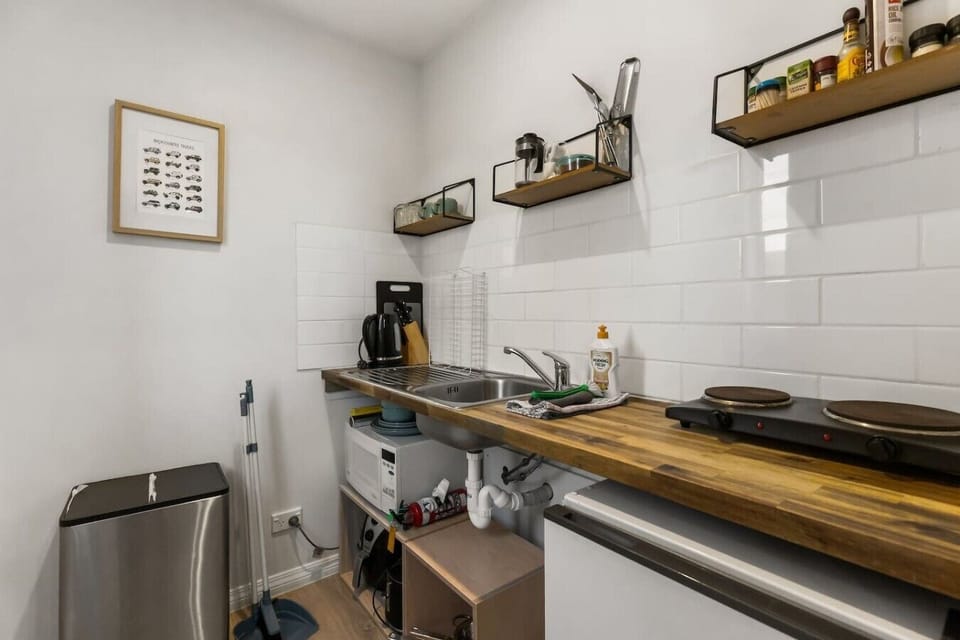 Fully equipped kitchenette with timber benchtop, microwave, coffee maker, hot plate and all the basic equipment you need to cook up a storm
