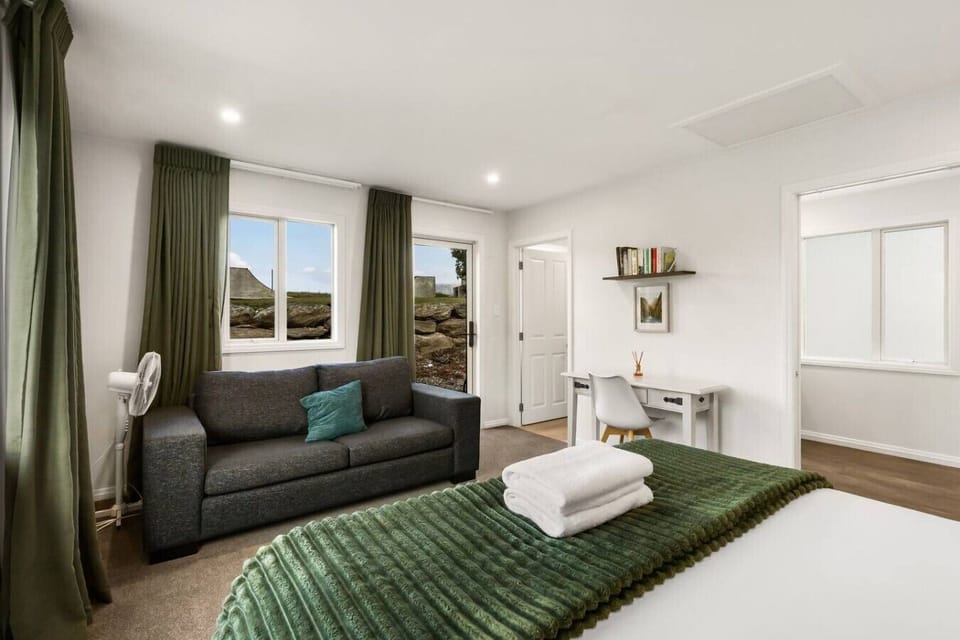 Relaxed lounge with plush sofa, teal accent cushions, and mountain views - the perfect spot to unwind after a day exploring.