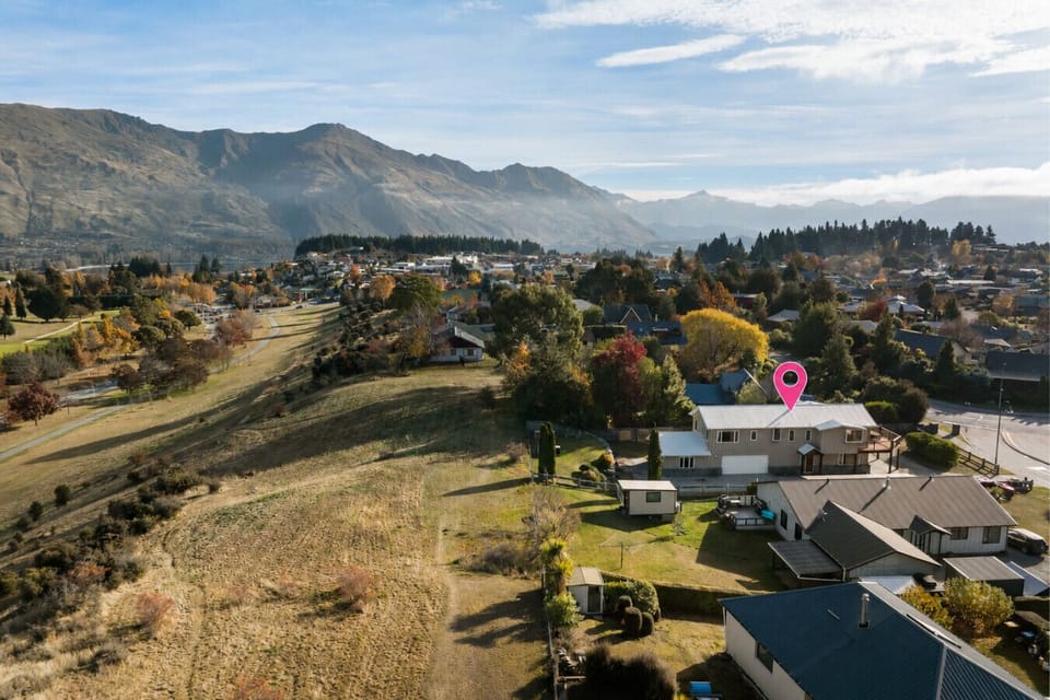 Aerial view over the neighbourhood with stunning mountain and lake backdrop