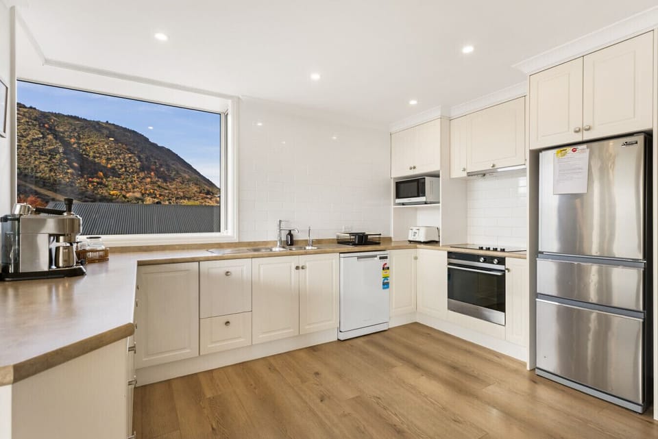 Chef`s kitchen with stainless steel appliances, double fridge, and mountain backdrop