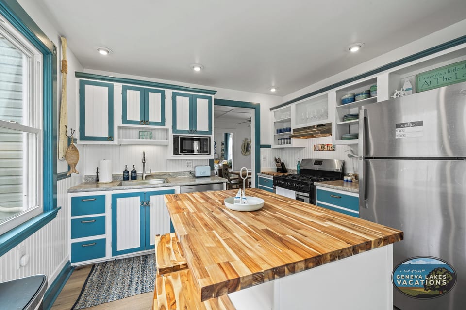 Kitchen with large island and two barstools