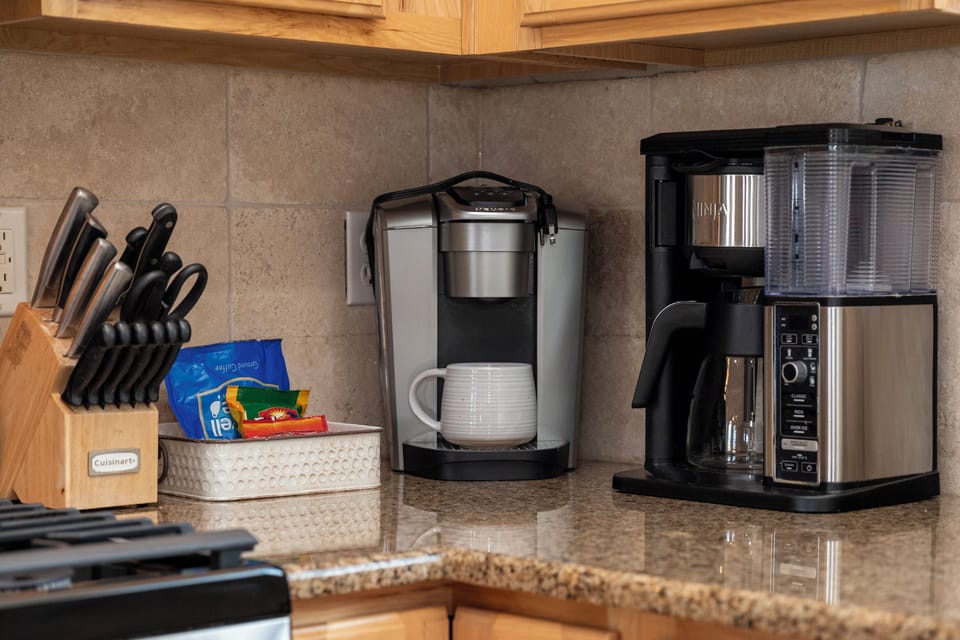 Your well-equipped kitchen coffee station awaits with premium brewing options and fresh supplies for perfect mornings.