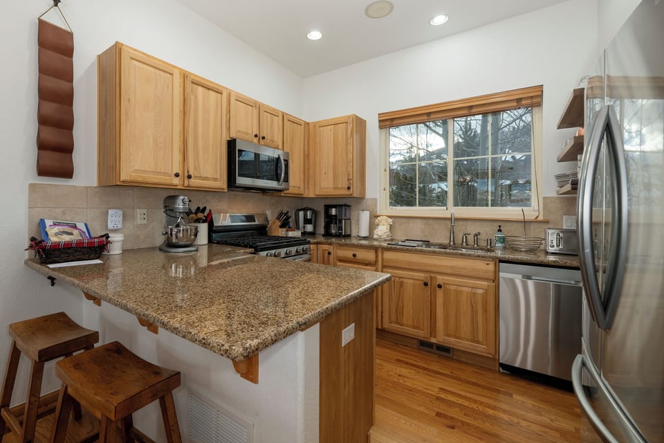 Your fully equipped kitchen features granite counters, stainless appliances, and everything you need to create memorable meals together.