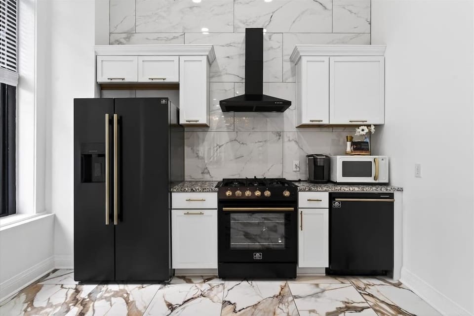 Here is a closer look at the chef-ready kitchen setup with plenty of counter space. The black and gold stove is ready for your culinary creations.