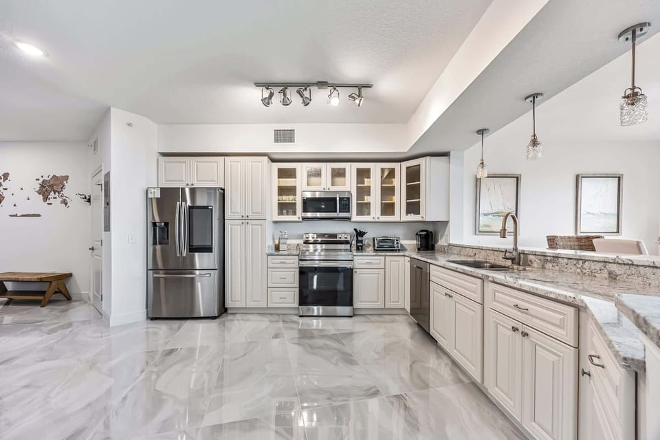 Modern kitchen with stainless steel appliances and granite countertops
