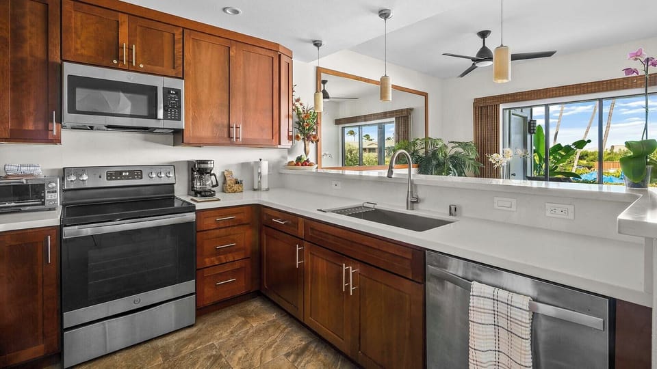 Your fully-equipped kitchen invites you to prepare meals with ease, featuring modern appliances, ample counter space, and tropical garden views that bring the island indoors.