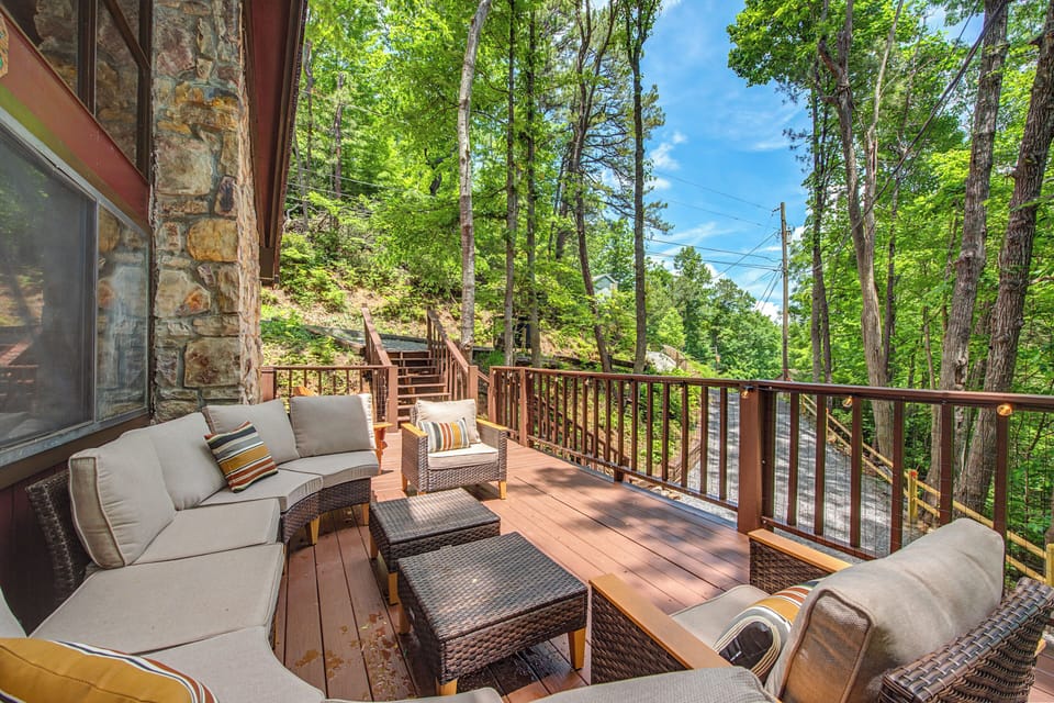 Your spacious private deck overlooks lush forest, offering plush seating, cool shade, and the perfect retreat for morning coffee or evening relaxation among the trees.