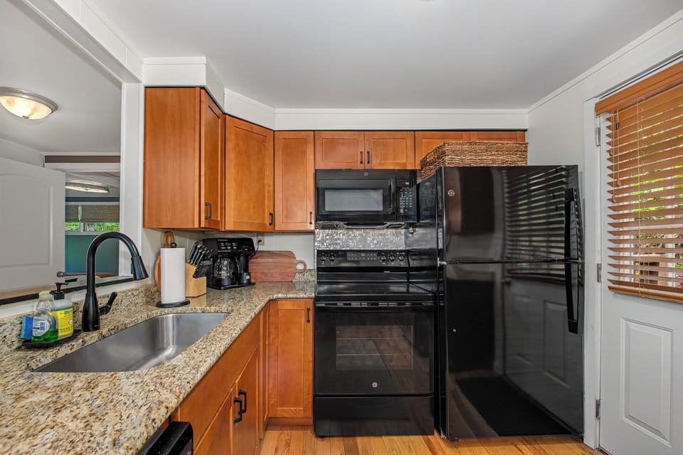 Your fully-equipped kitchen awaits with granite counters, modern appliances, and plenty of cabinet space for preparing meals during your stay.