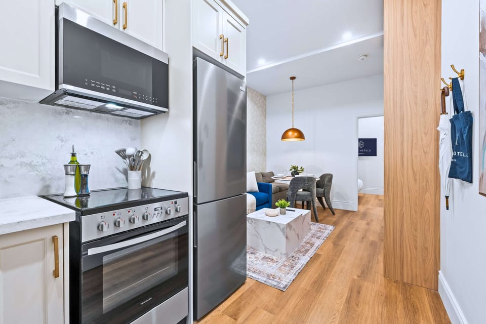 Open kitchen, dining, and living area with bedroom for a complete stay experience