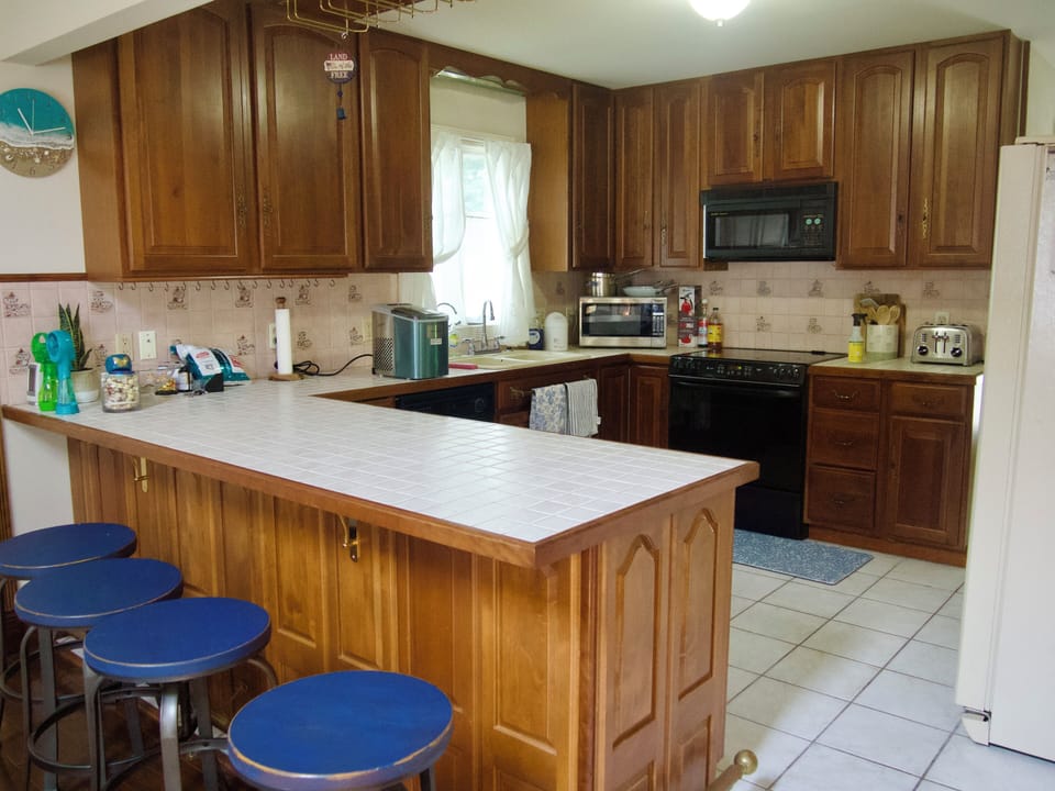 Kitchen opens to the dining room. Counter that seats 4