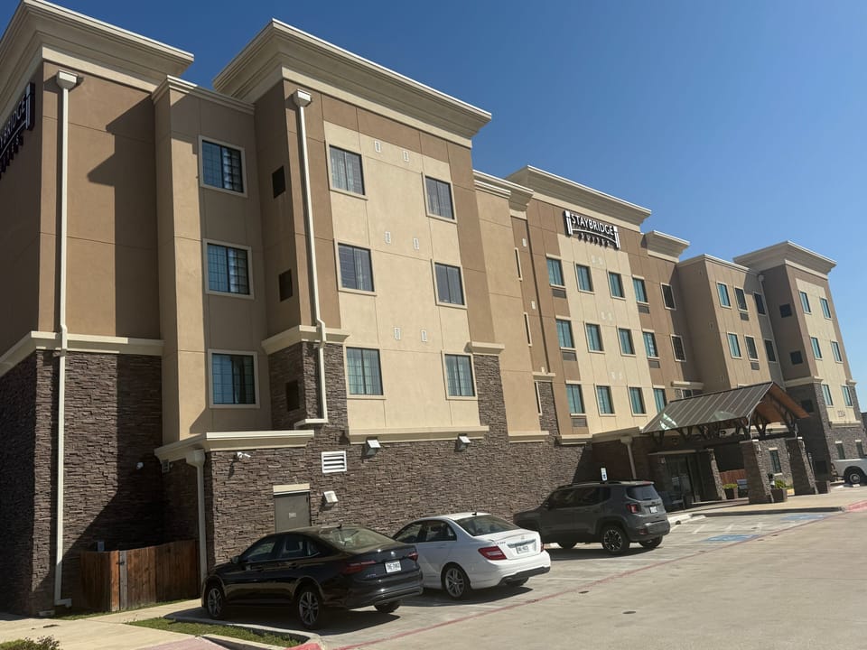 Exterior view of a multi-story building with a blue sky.