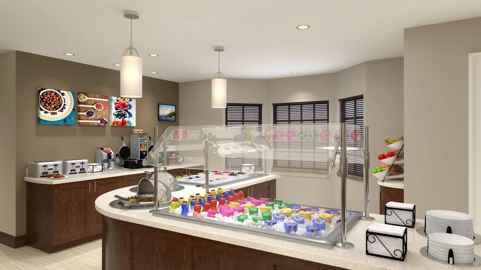 Complimentary breakfast area with hot and cold selections.