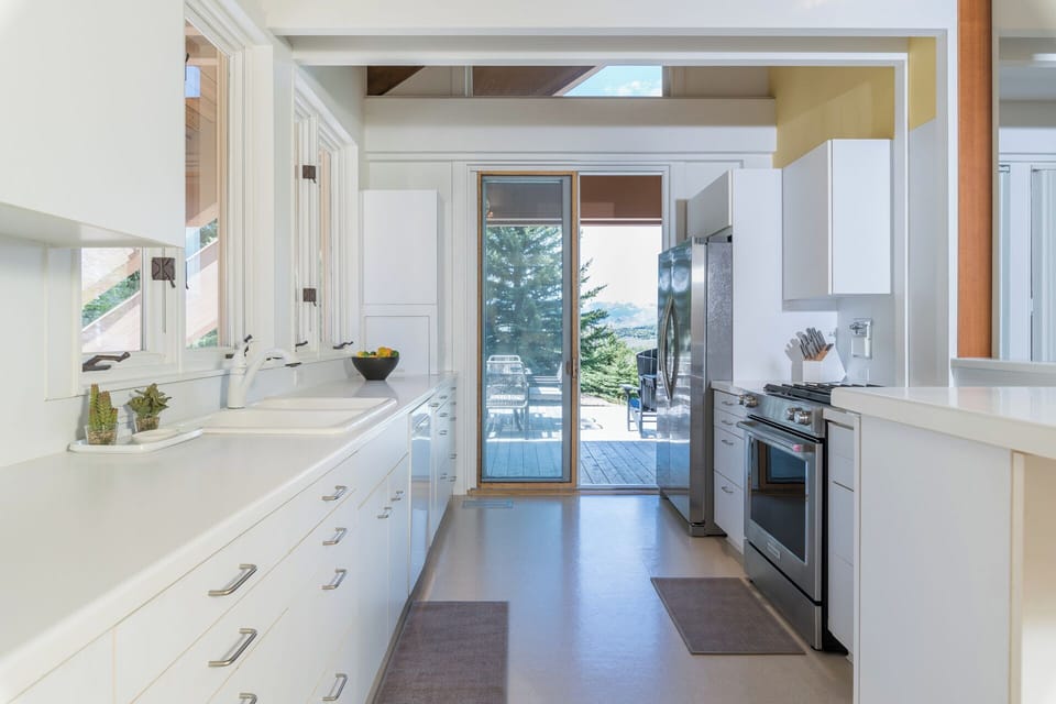 Your spacious, light-filled kitchen features modern appliances and opens to a stunning deck with lake views—perfect for cooking while enjoying the scenery.