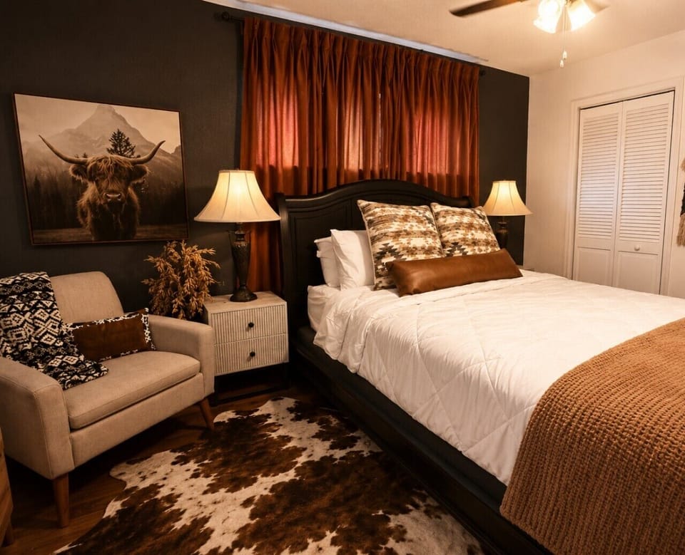 Rest easy in the cozy queen bedroom, beautifully decorated with rustic western touches for a warm, inviting night`s sleep.