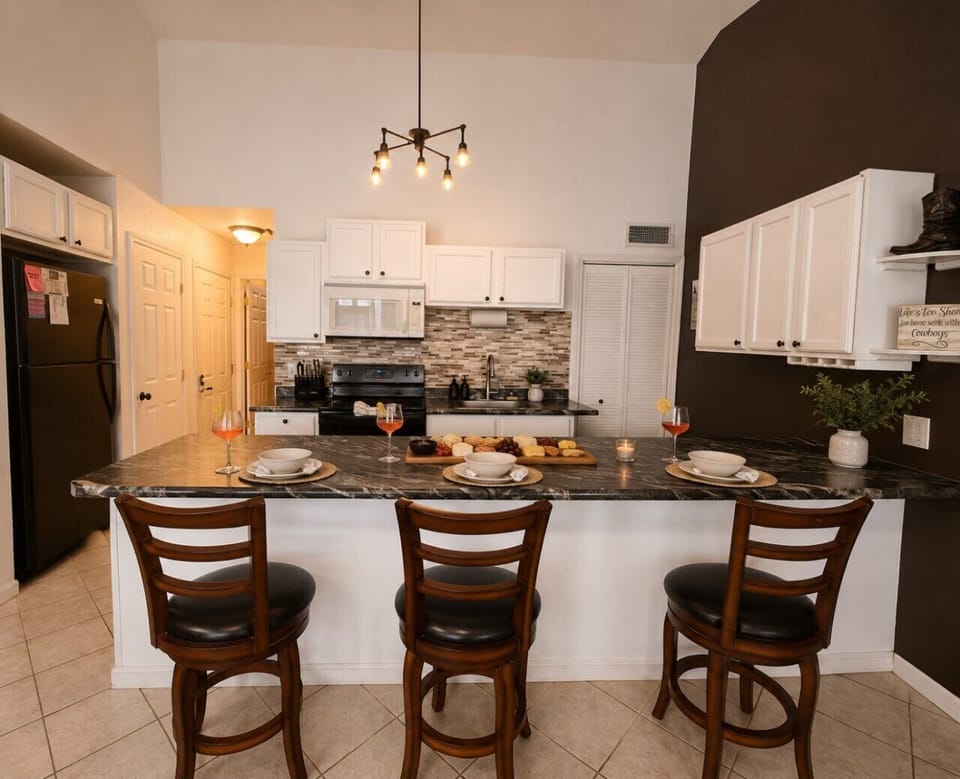 Gather around the granite dining table after a day on the water — the kitchen has everything you need to eat in and unwind.