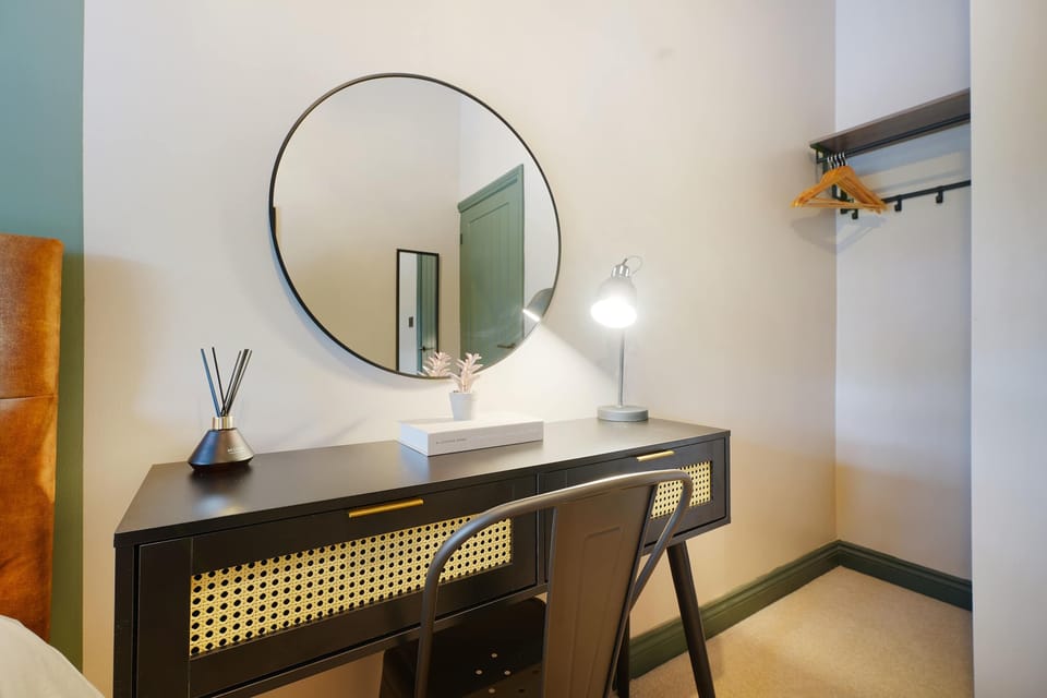 A well-appointed single bedroom that blends comfort with practicality, featuring a cosy sleeping area, workspace, dressing table, and storage solutions. Ideal for guests seeking both relaxation and functionality.