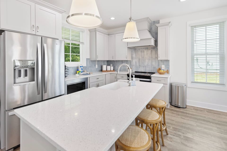 Your bright, fully equipped kitchen invites you to whip up meals with stainless steel appliances, elegant quartz countertops, and a welcoming island for gathering over morning coffee.
