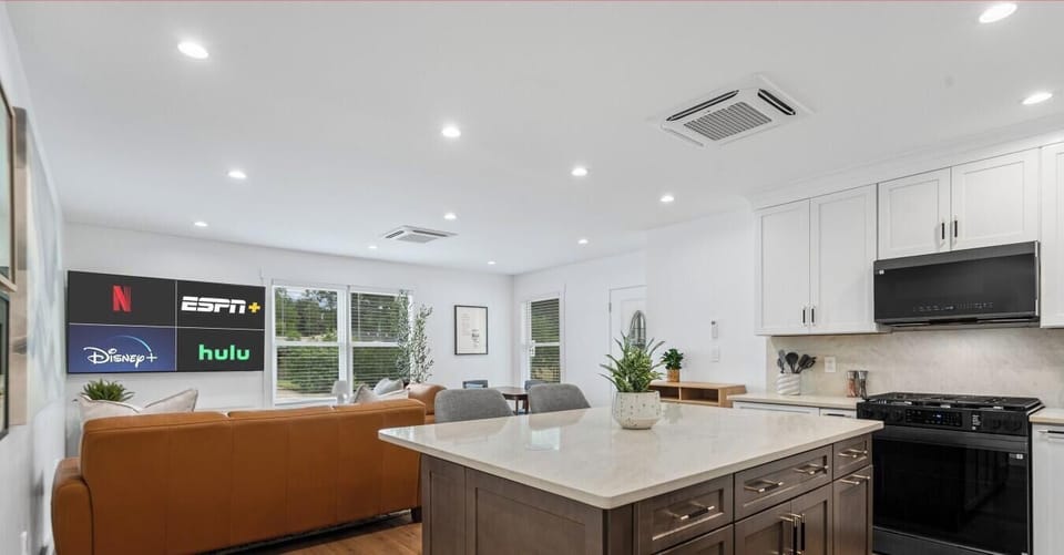 Gather around the oversized kitchen island or settle into the living room — open sightlines keep everyone connected.