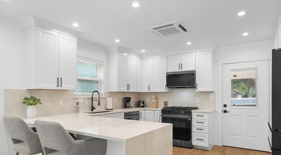 The open kitchen layout offers plenty of room for multiple cooks and a breakfast bar for quick morning bites.