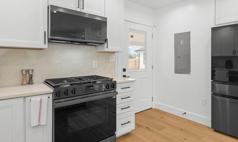 Black stainless appliances and a gas cooktop give you everything to whip up home-cooked meals with ease.