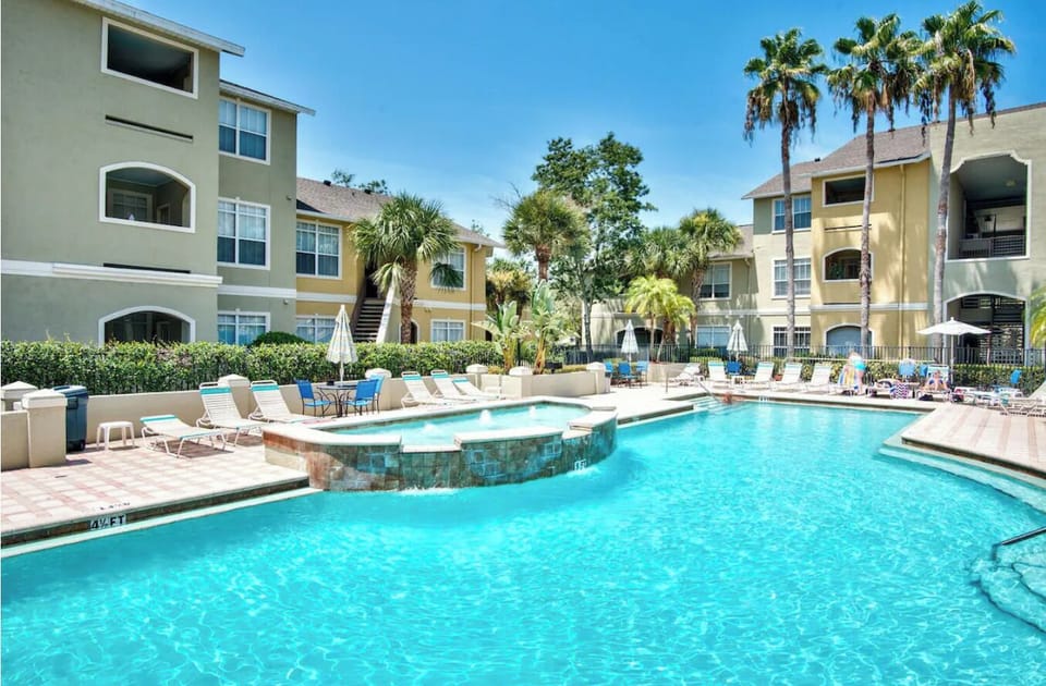 Gorgeous oversized pool with loungers and umbrellas