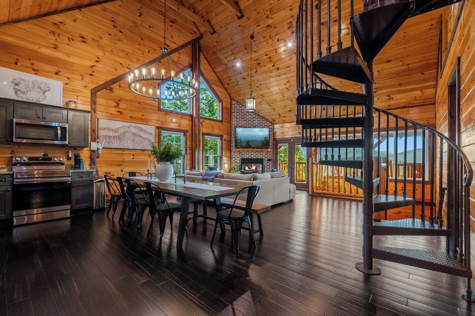 Vaulted wood-beam main level with fireplace, dining space, and fireplace