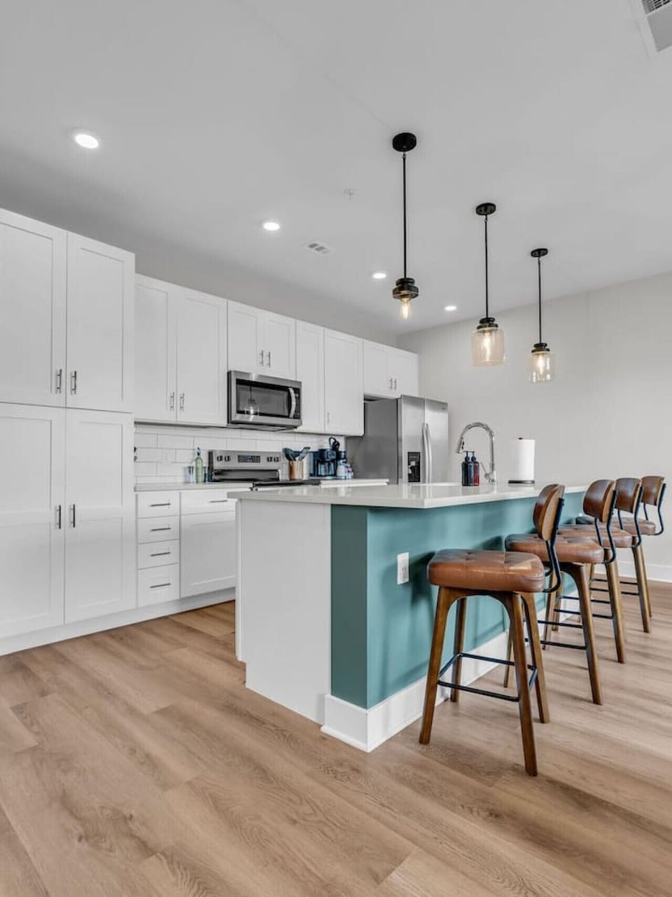 Kitchen: Stylish space with modern appliances and inviting bar seating for casual dining fun!