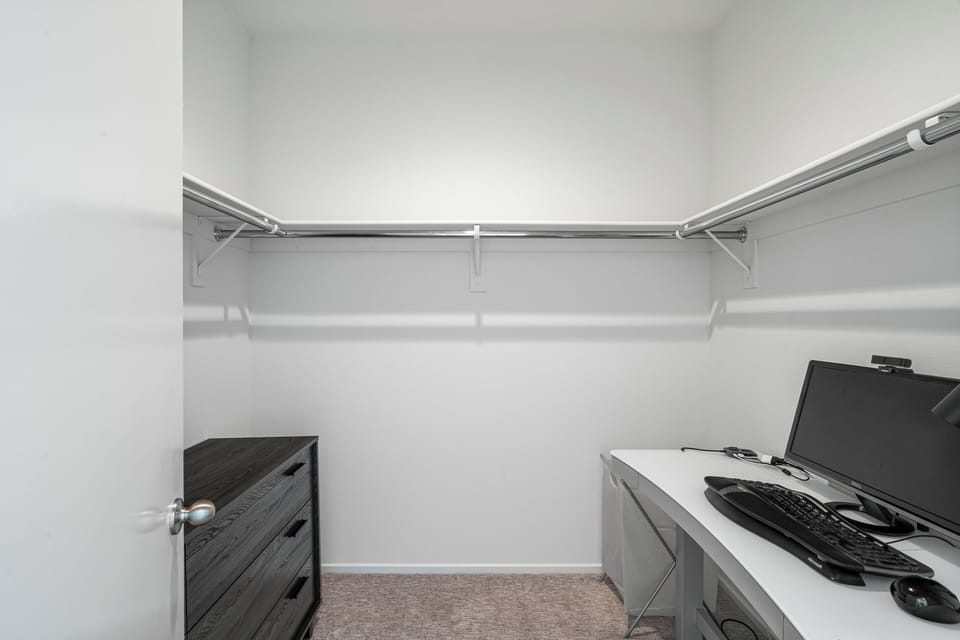 Primary bedroom walk-in closet