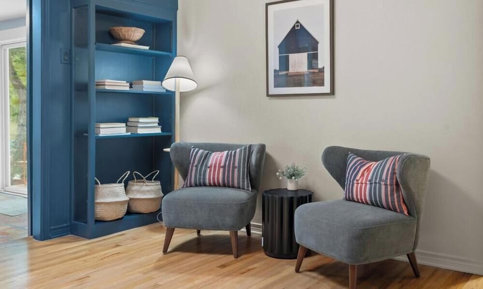 Tuck away with a good book in this quiet sitting nook. Two armchairs and warm lighting set the mood.