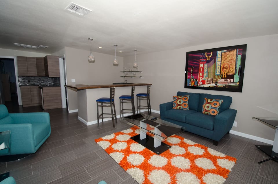 Exclusive Suite, 1 King Bed, Patio, Poolside | Living room | Flat-screen TV