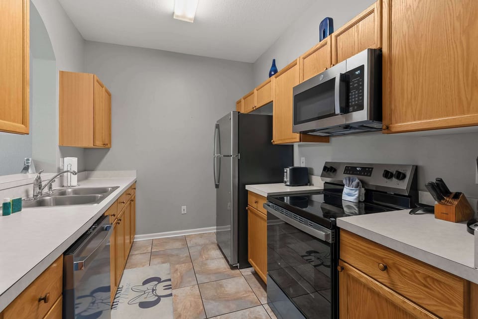 Functional kitchen with stainless steel appliances and ample wooden cabinetry