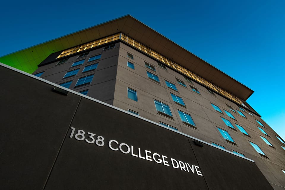 Contemporary building exterior with striking angles and large windows.