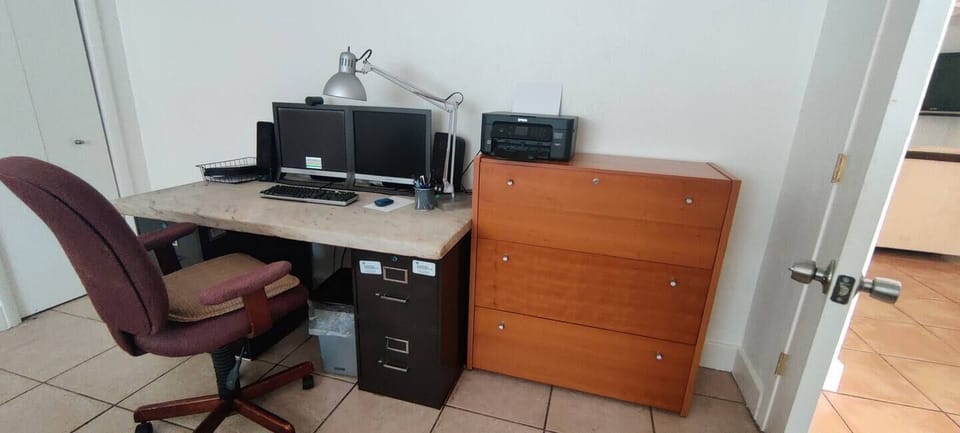 Dedicated workspace with desk, monitor, and storage