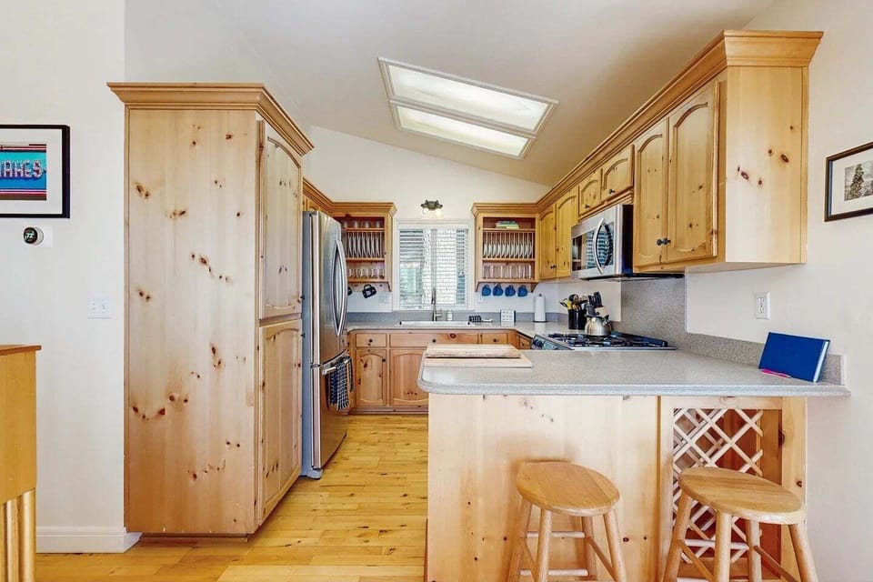 Stainless steel appliances, counter seating for 2, and kitchen essentials.