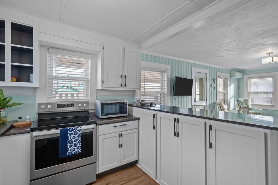 Fully equipped kitchen with modern appliances and natural light